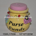 Yellow ceramic money bank with chain decorations